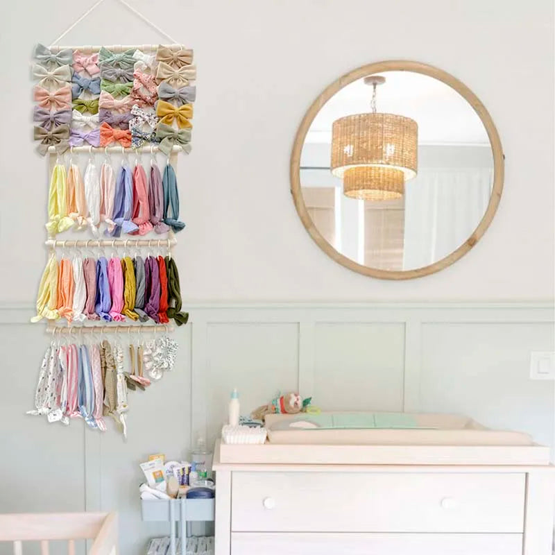 Wall-mounted headband holder displaying colorful fabric headbands and a round mirror above a white dresser.