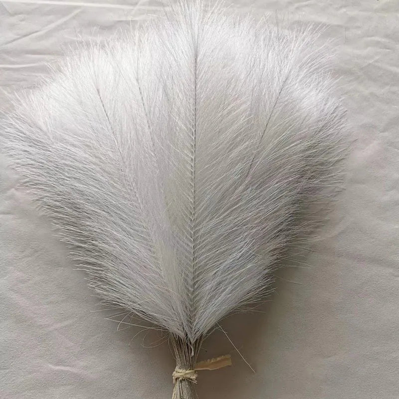 A fluffy white artificial pampas grass plume used for boho home decor.