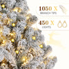 Flocked artificial Christmas tree decorated with warm white LED lights and branch tips