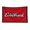 A red flag featuring the white text Edelbrock on a black border.