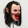 Lifelike vampire mask of a female creature with pale skin, long dark hair, and bloody fangs.