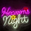 Neon sign spelling out Heavens Night in pink and white glowing script on a dark background