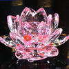 A pink crystal lotus flower ornament with multiple layers and facets, reflecting light.