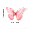 Pink butterfly patch with embroidered details shown against a white background.