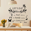 Black silhouette wall decal featuring the text Let's Eat Bless the Food the Family beside us and the Love between us with flo