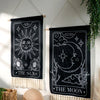 Black sun and moon boho wall tapestry featuring celestial designs on a black fabric.