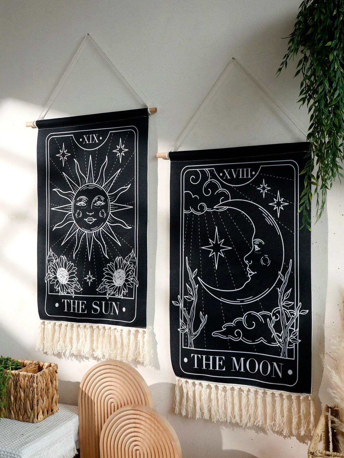 Black sun and moon boho wall tapestry featuring celestial designs on a black fabric.