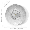 A round silver wall clock with a textured, sunburst design and a black face.