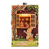 A wooden layered puzzle magnet decor featuring a rabbit in a house with floral accents.