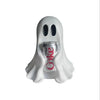 A white ghost figurine holding a silver soda can, used as quirky tabletop decor.