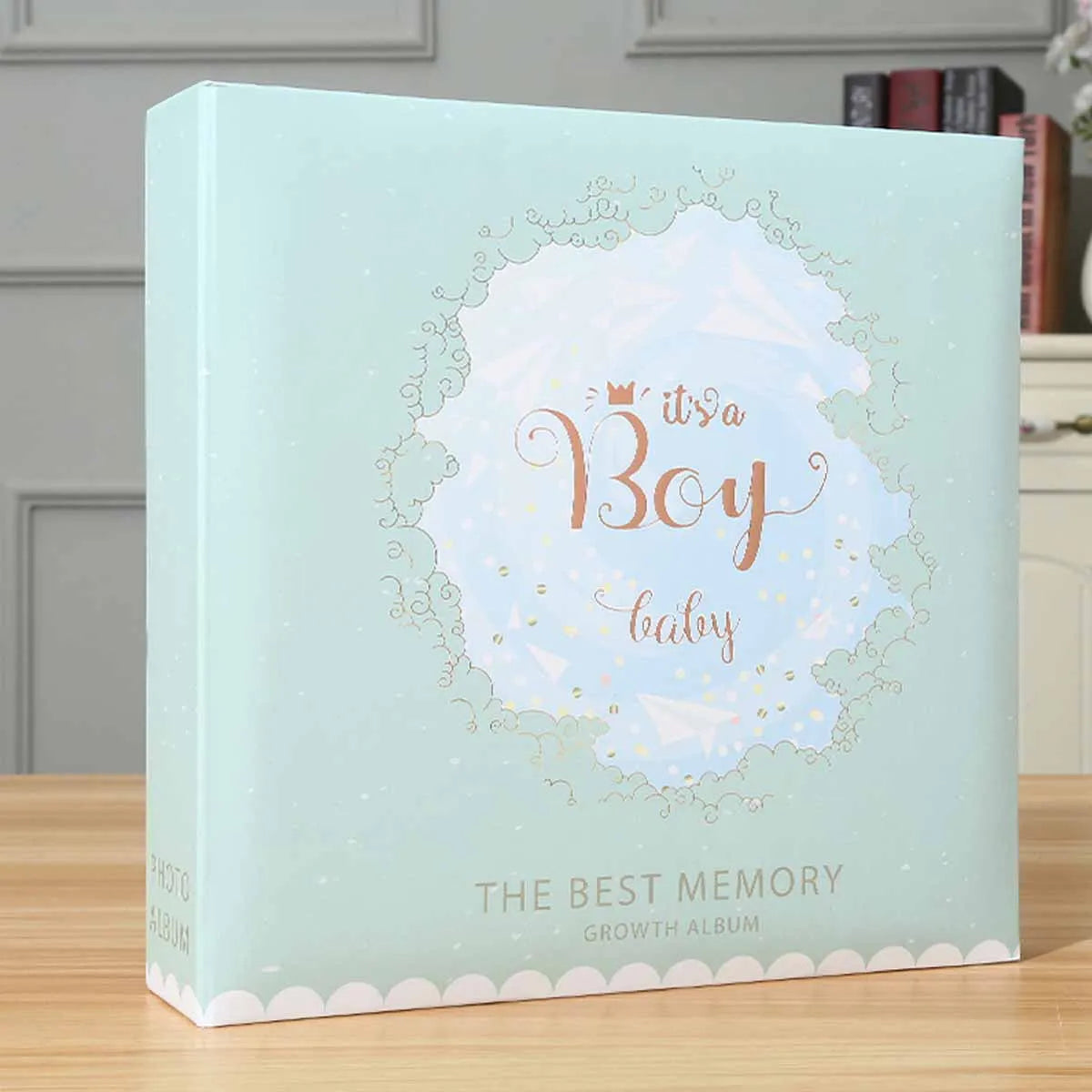 A light blue photo album cover featuring a gold crown design and the text Its a Boy baby The Best Memory Growth Album