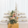 Elegant white and gold disposable dinnerware set with cutlery displayed on a table.