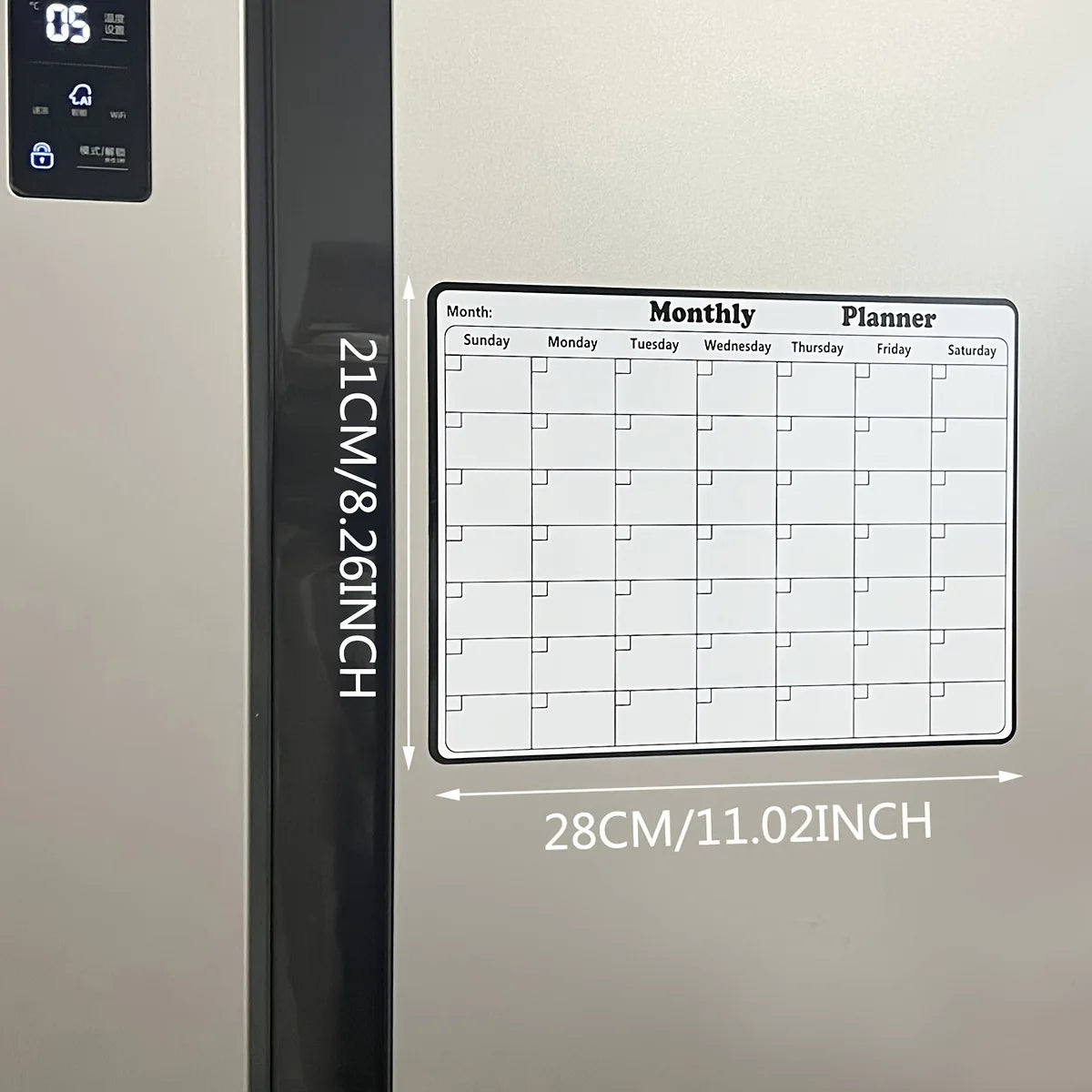 A monthly planner calendar displayed on a refrigerator door, showing days of the week and grid lines.