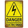 A vintage yellow warning sign indicating danger of electric shock with a lightning bolt symbol.