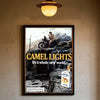 Vintage poster featuring a sepia-toned illustration of a man and a camel with the text Camel Lights Its a whole new world.