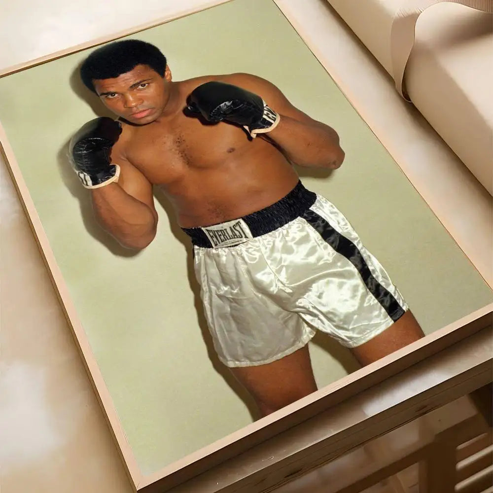 A muscular man wearing boxing gloves and shorts poses for a Muhammad Ali classic boxing poster.
