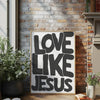 Black text on a white background featuring the phrase Love Like Jesus framed in light wood