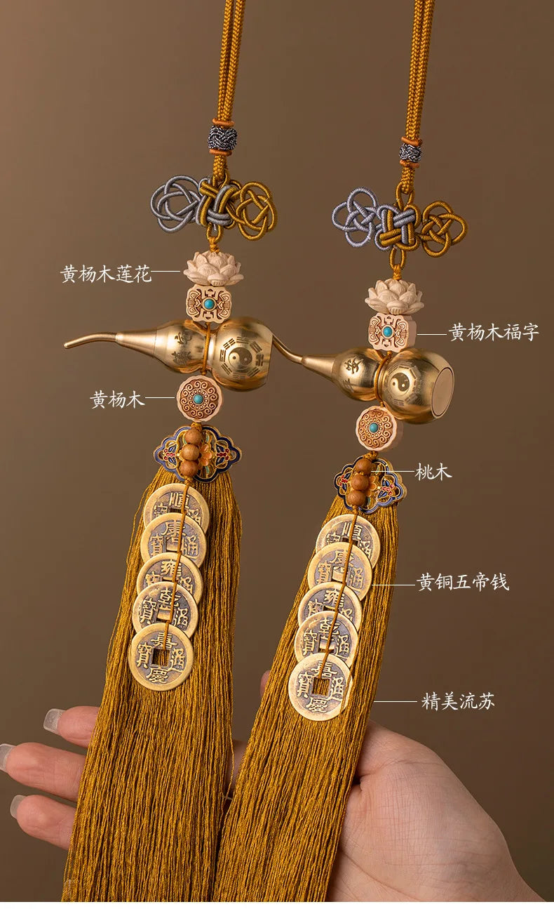 A pair of brass gourd and five emperor coins hanging ornaments made of golden yellow silk thread.