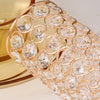 A close-up of a crystal gold flower vase featuring intricate, round-cut glass detailing.