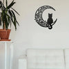 Black cat silhouette inside a crescent moon design wall decor sculpture on a white wall.