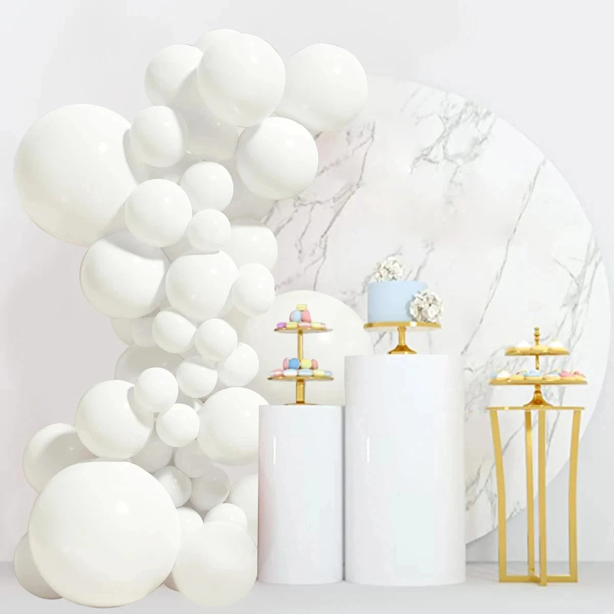 A white latex balloon garland arch kit featuring white and beige balloons displayed against a marble background.