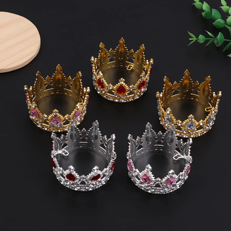 A set of four decorative crown toppers and hair accessories featuring gold, silver, and pink pearl accents.