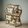 A rotating wooden photo frame display with twelve slots, mounted on a metal stand.