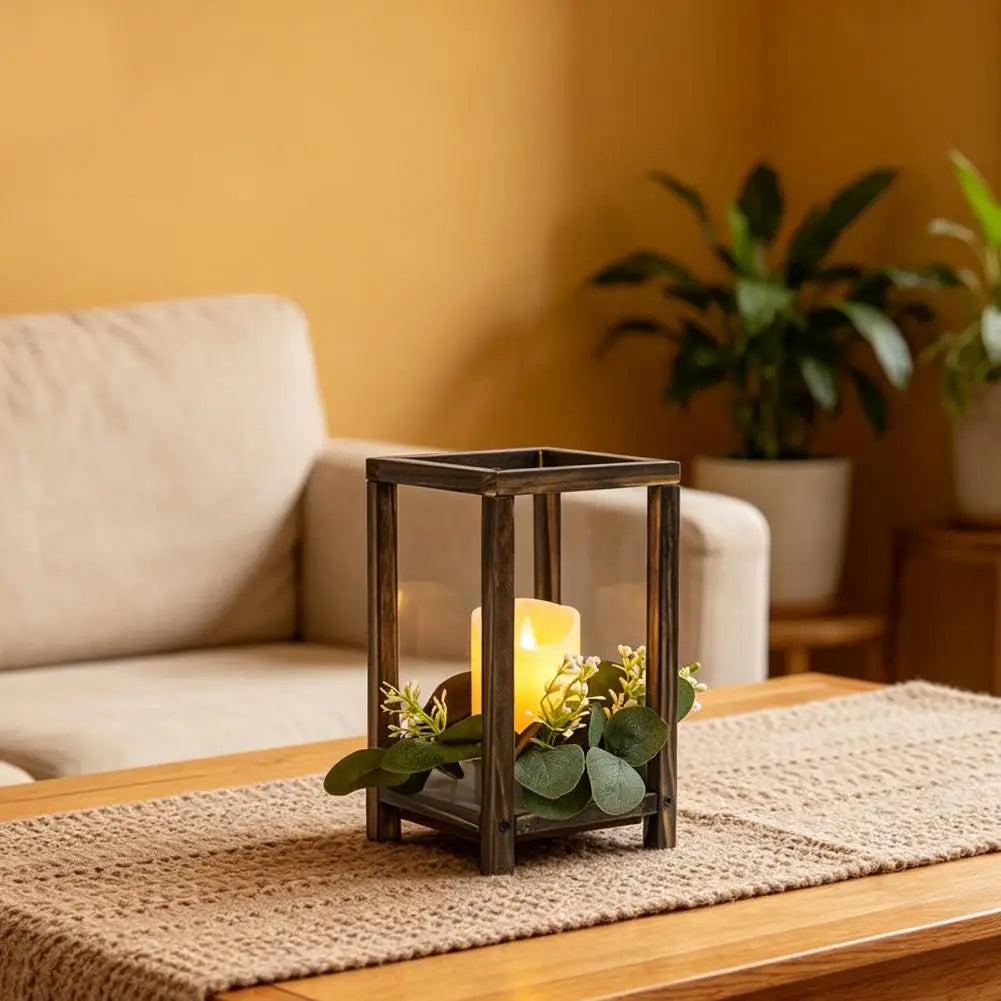 A rustic wooden candle holder lantern sits on a light brown woven mat on a wooden table.