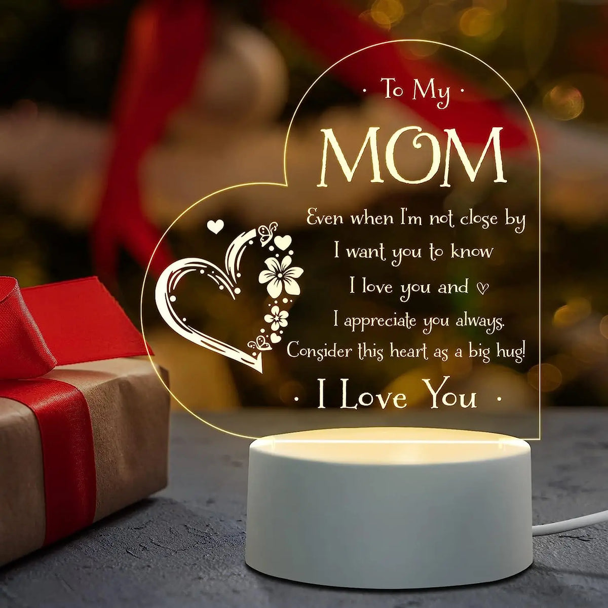 A glowing heart-shaped sign with the message To My Mom I love you and I appreciate you always I love you displayed on a white