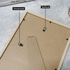 A wooden photo frame with horizontal and vertical alignment markers shown on the surface.