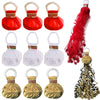 A collection of red and gold paper streamers, including pom-pom shaped decorations and long flowing streamers.