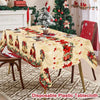 Vintage Christmas tablecloth featuring red poinsettia and bell designs on a cream fabric.