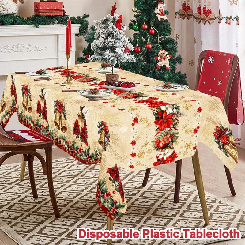 Vintage Christmas tablecloth featuring red poinsettia and bell designs on a cream fabric.