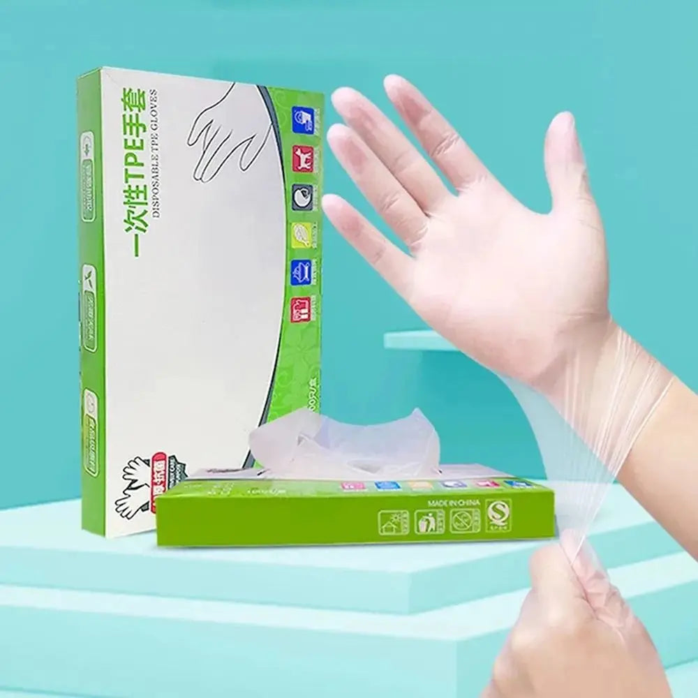 A hand wearing a clear disposable safety glove is shown next to the product packaging for heavy-duty disposable safety gloves