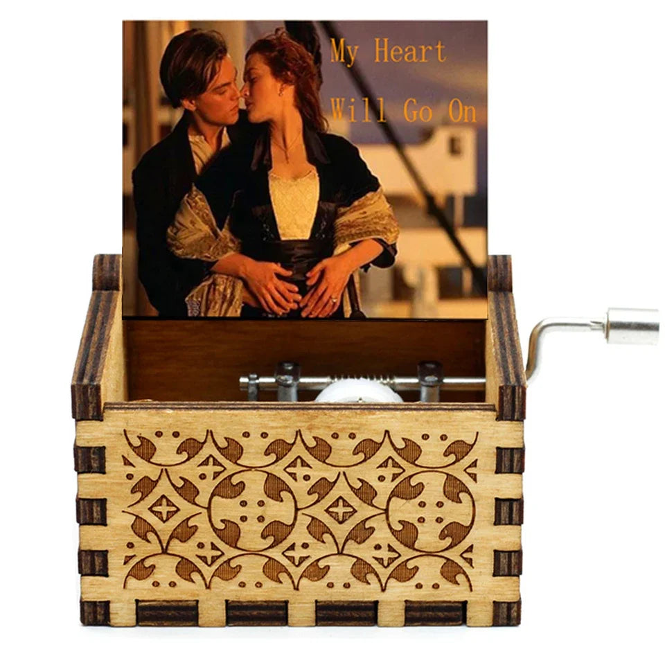 A carved wooden music box featuring a scene of two people kissing, set in a decorative wooden box.