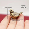A handcrafted brass rooster figurine shown in a person's hand, measuring 1.93 cm long and weighing about 18g.