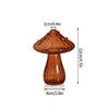 Vase décoratif en verre brun en forme de champignon avec chapeau et pied, sur fond blanc.