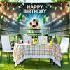 A soccer field party backdrop featuring balloons and a cake set up for a birthday celebration.
