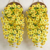 A pair of artificial eucalyptus and violet pansy hanging vines with yellow flowers.