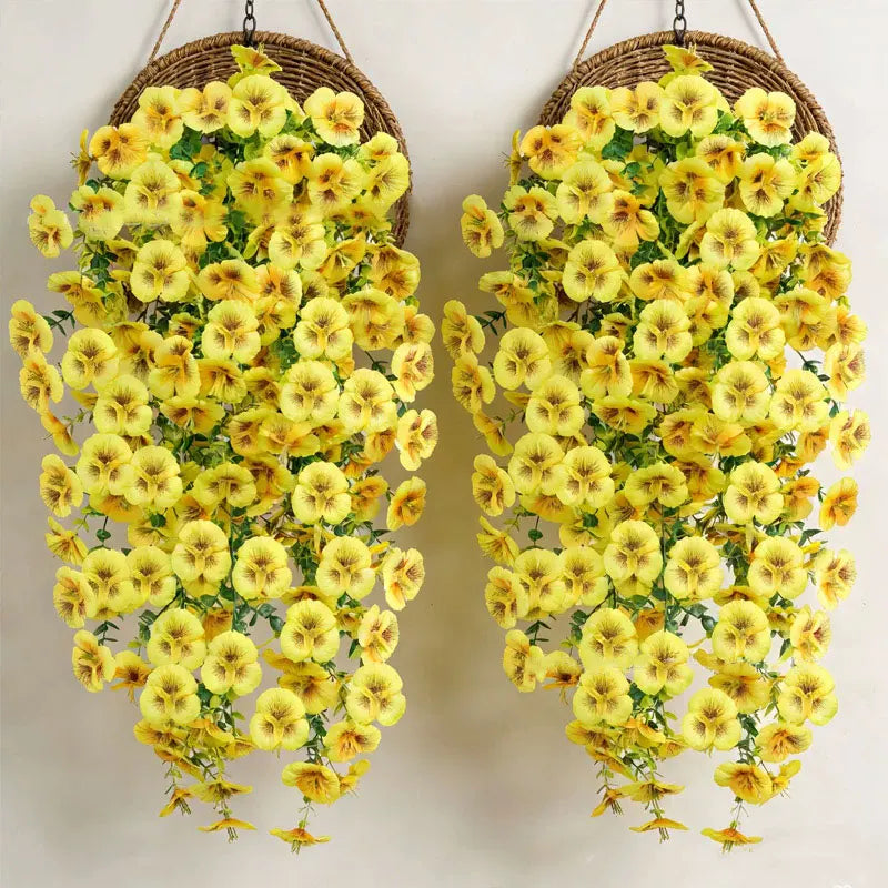 A pair of artificial eucalyptus and violet pansy hanging vines with yellow flowers.