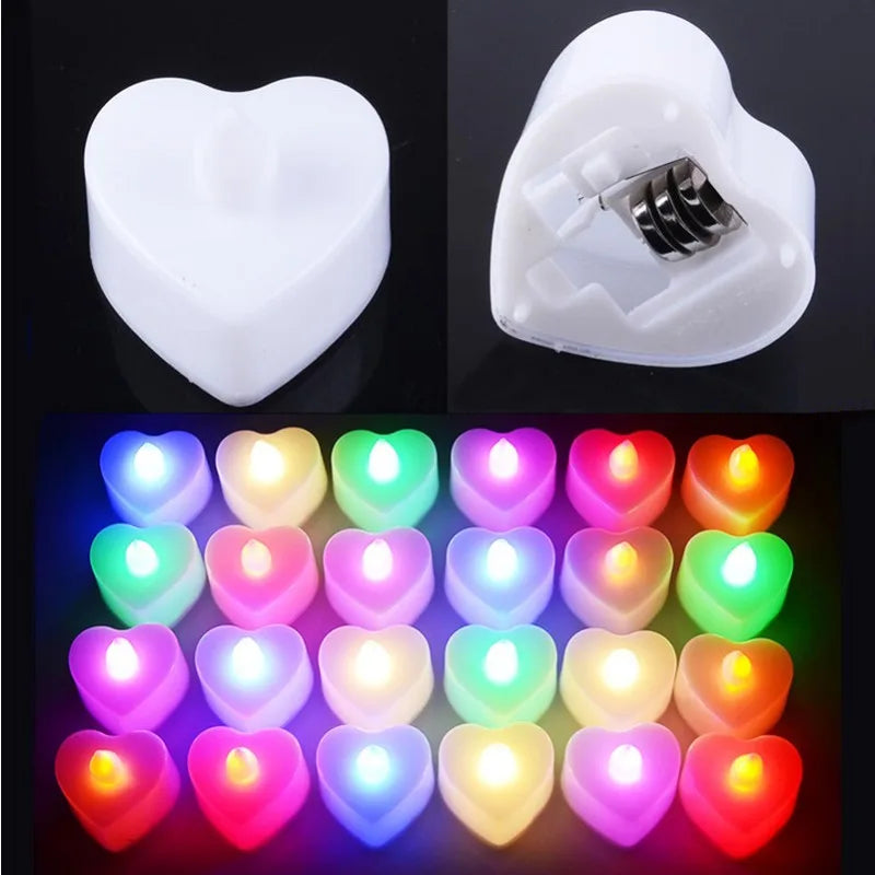 A collection of heart-shaped flameless LED tealight candles in various colors including pink, purple, green, and orange.