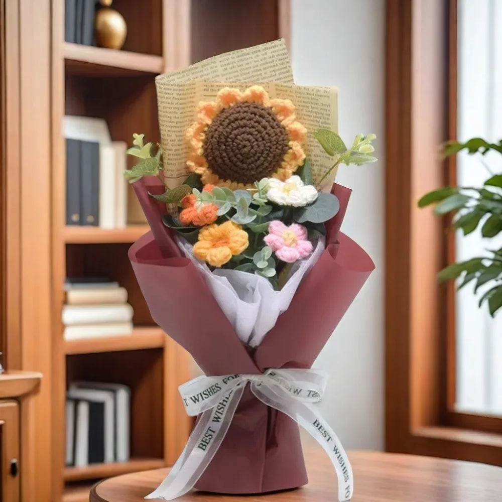 A handmade sunflower daisy crochet bouquet wrapped in a mauve paper and tied with a white ribbon.