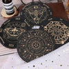 A collection of black wooden divination cards featuring celestial symbols and zodiac signs for meditation