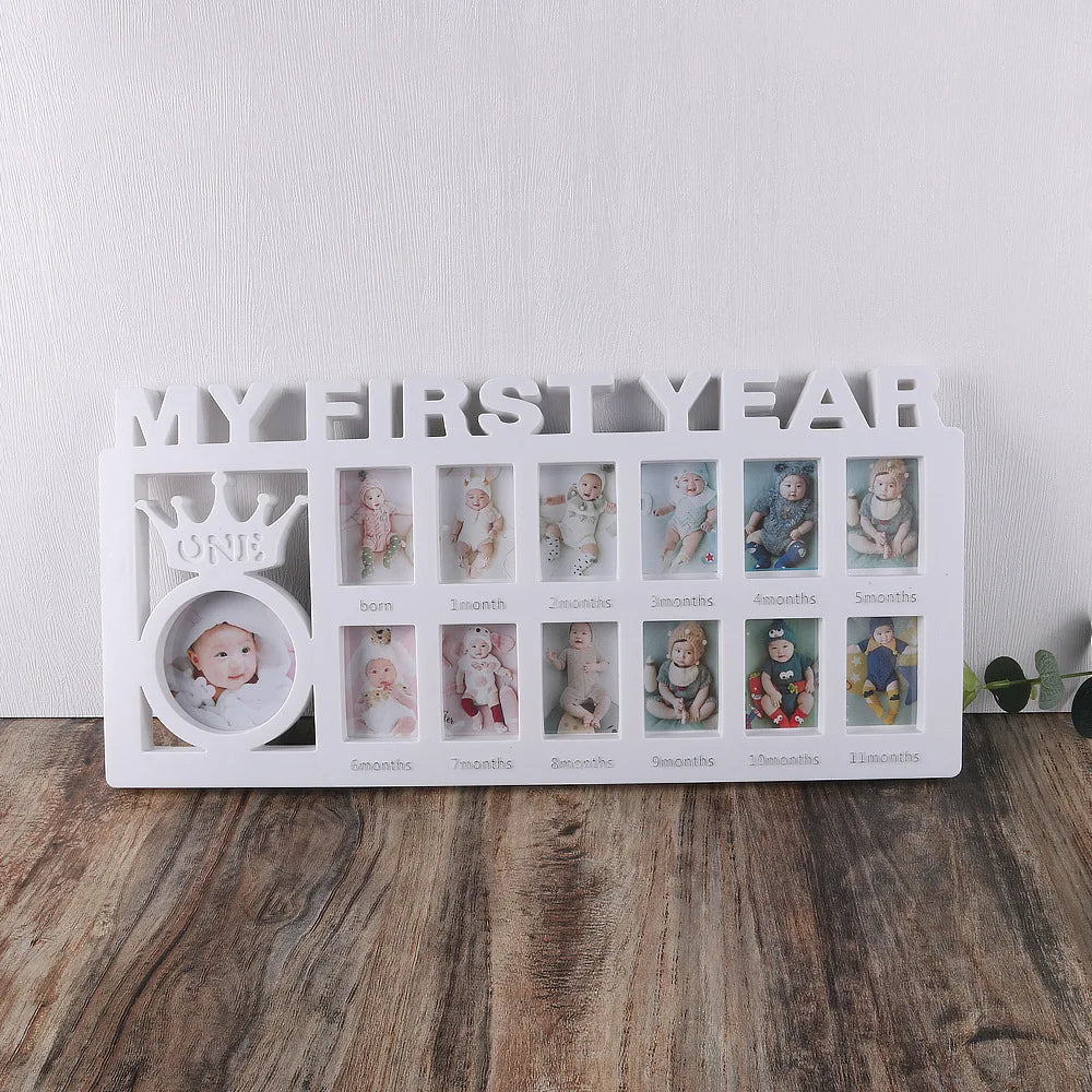 A white photo frame display showing twelve monthly growth photos of a baby, labeled from one month to one year.