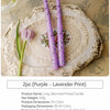 Two purple long-stemmed candles with a lavender print displayed on an ornate plate.