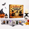 A Halloween mystery box featuring a wooden plaque with spooky designs and various small figurines.