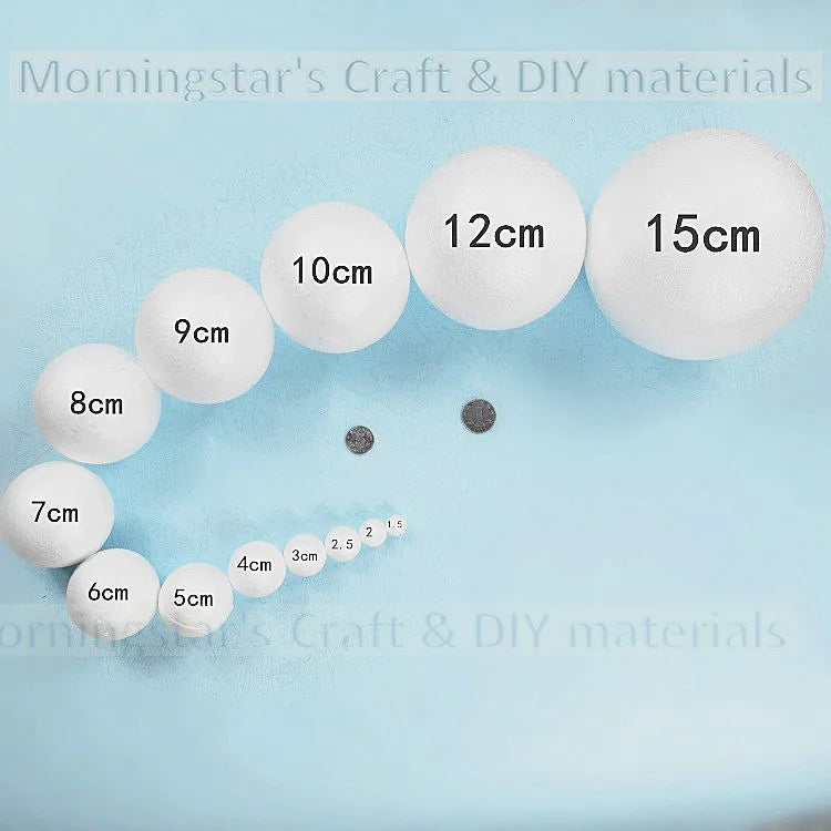 A collection of white polystyrene foam balls of various sizes, ranging from 5cm to 15cm, displayed on a light blue surface.