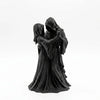 A dark romantic sculpture depicting a couple in hooded figures, resembling a Gothic Grim Reaper theme.