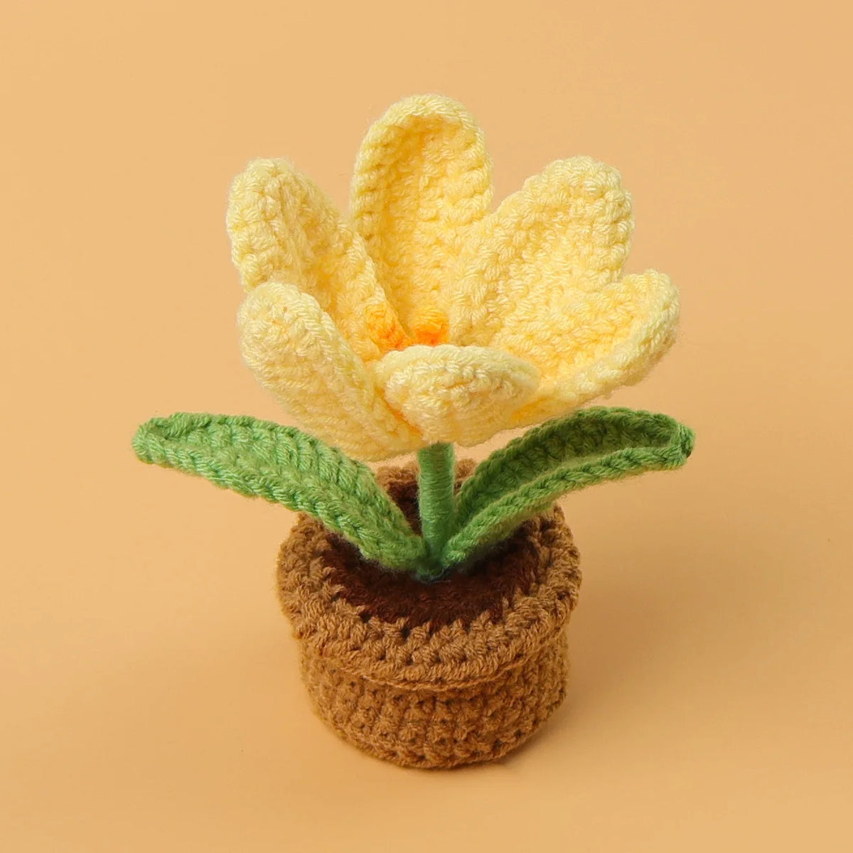 Handcrafted crochet yellow tulip flower growing in a brown felt pot