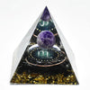 Handmade resin orgonite pyramid featuring natural obsidian and a copper coil.